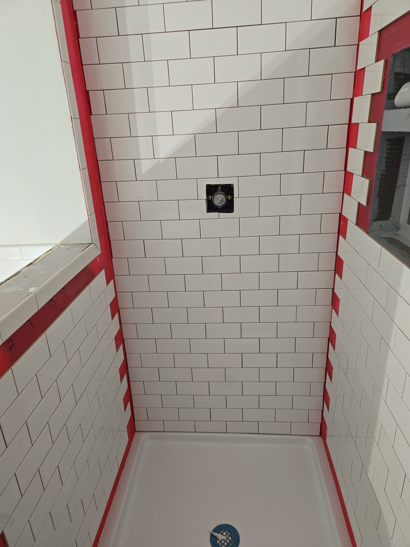 White subway tile installation