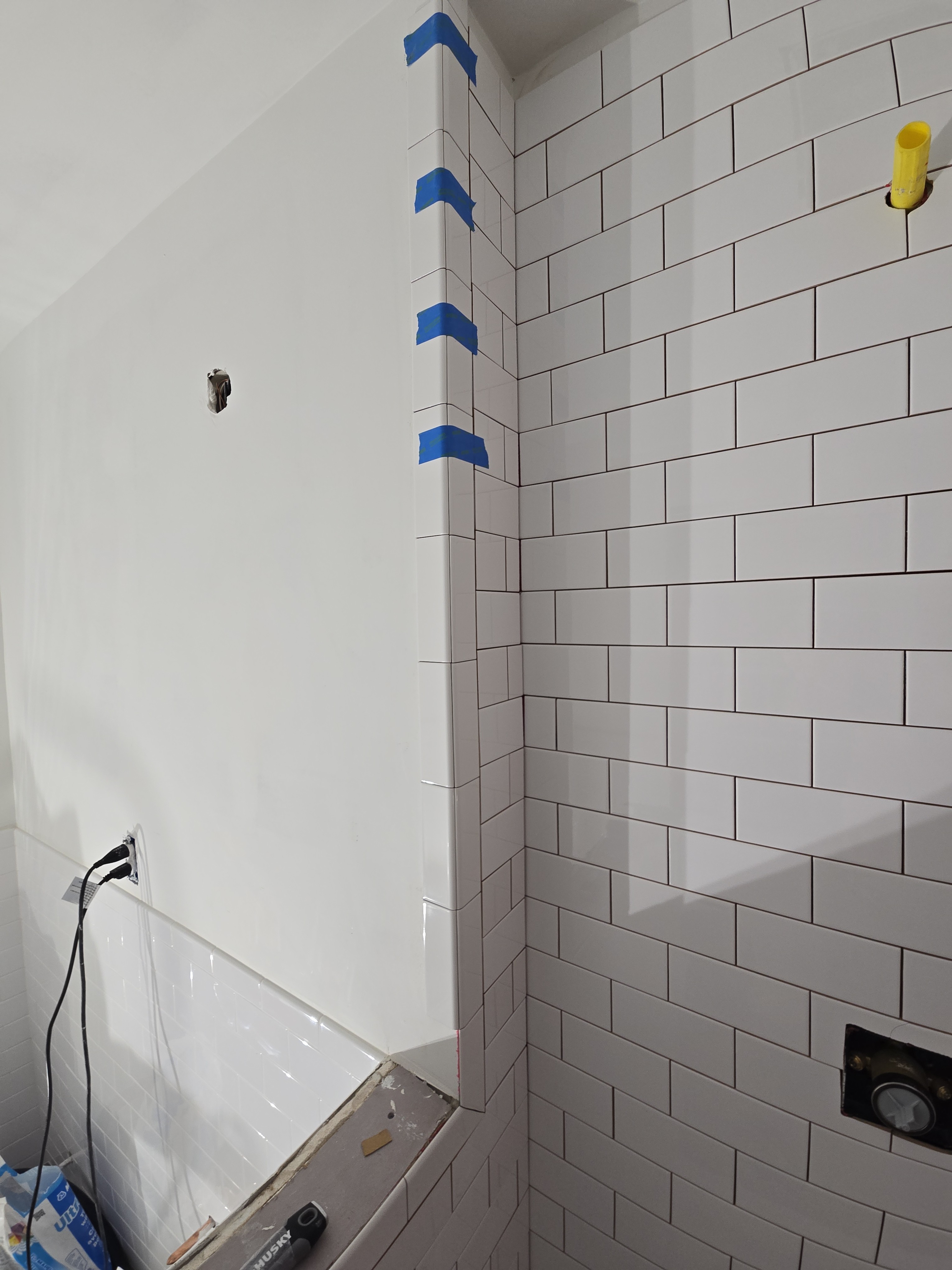 Detailed subway tile installation in progress