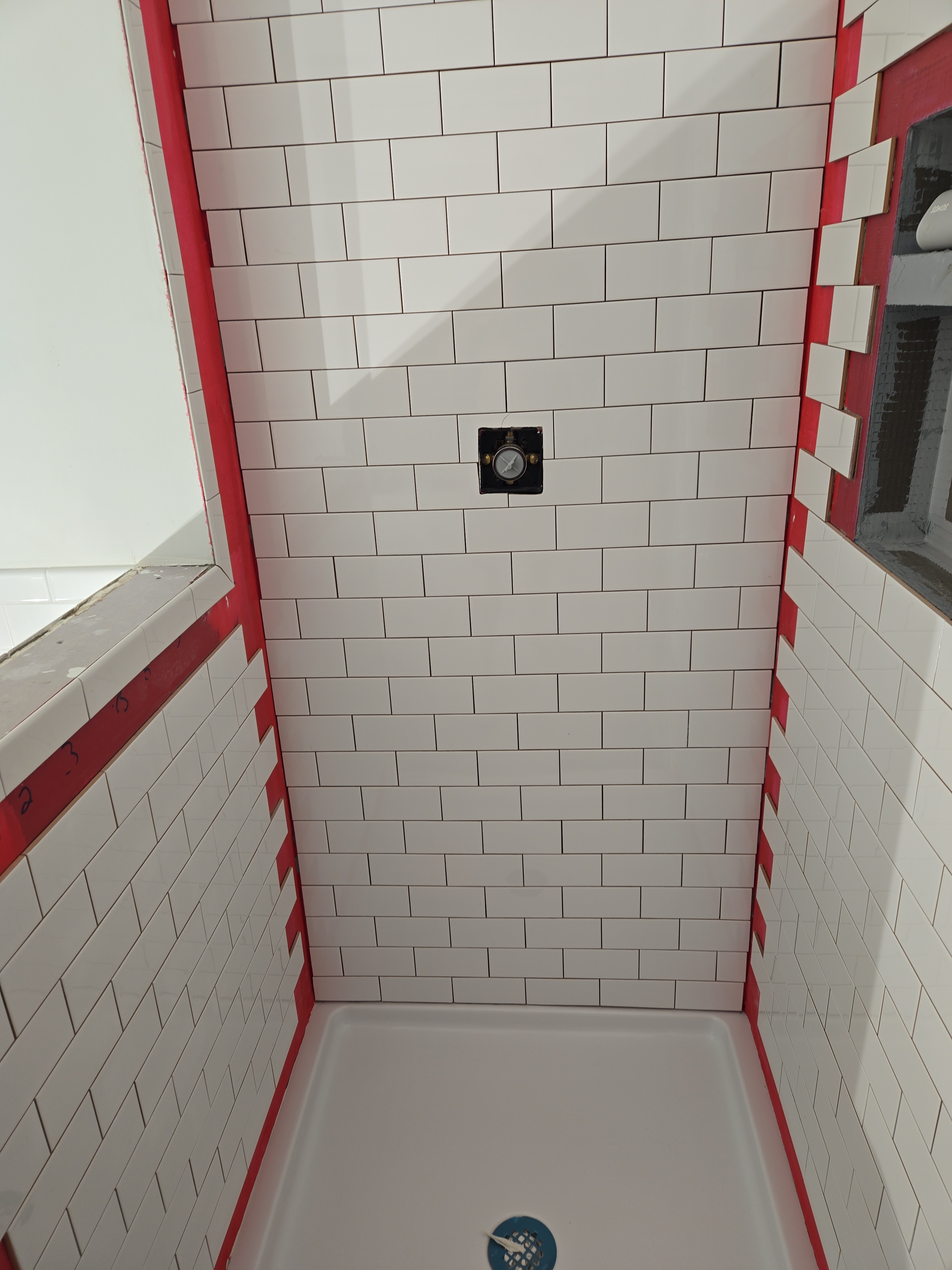 White subway tile installation