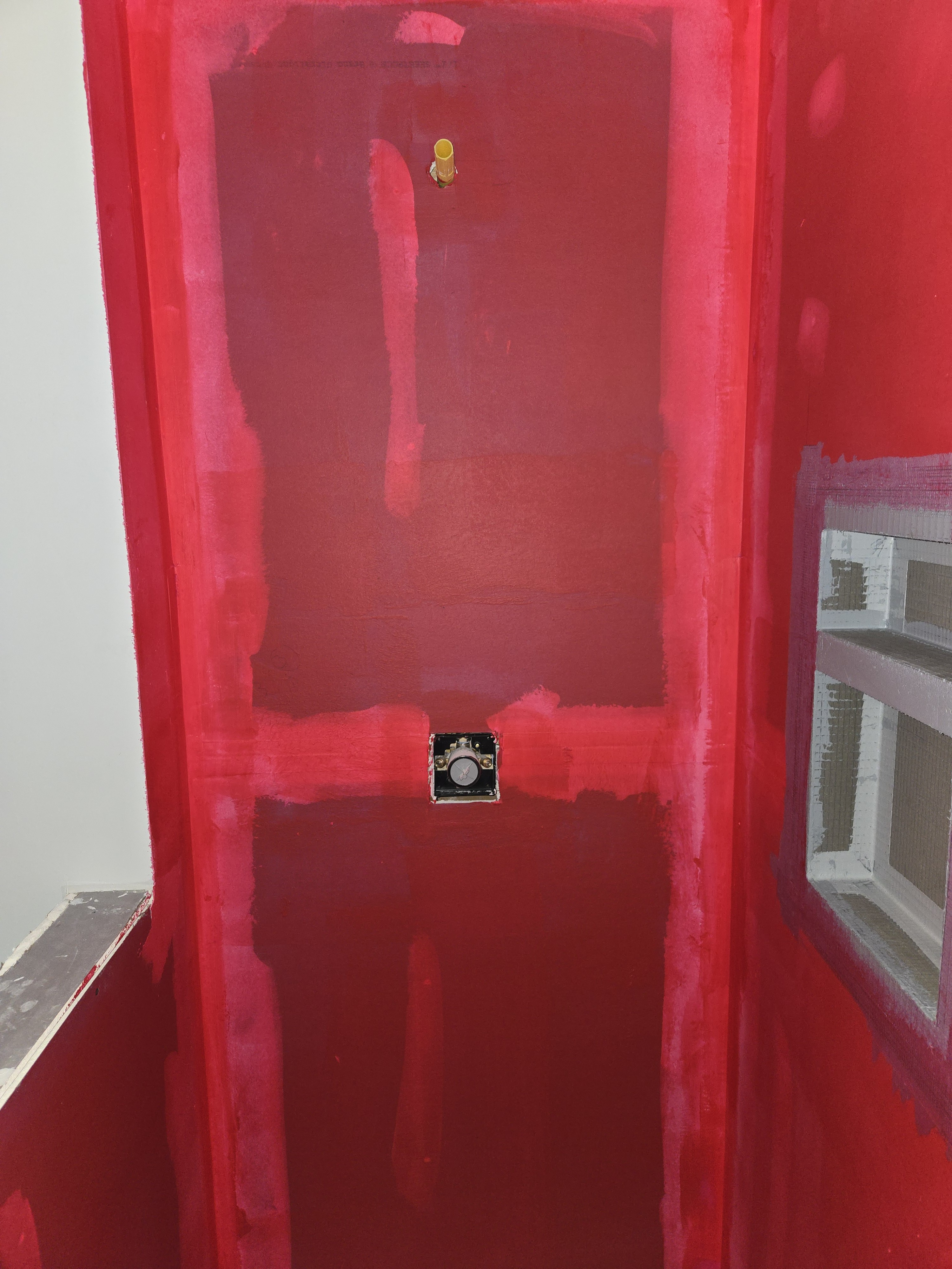 Red waterproofing membrane in shower